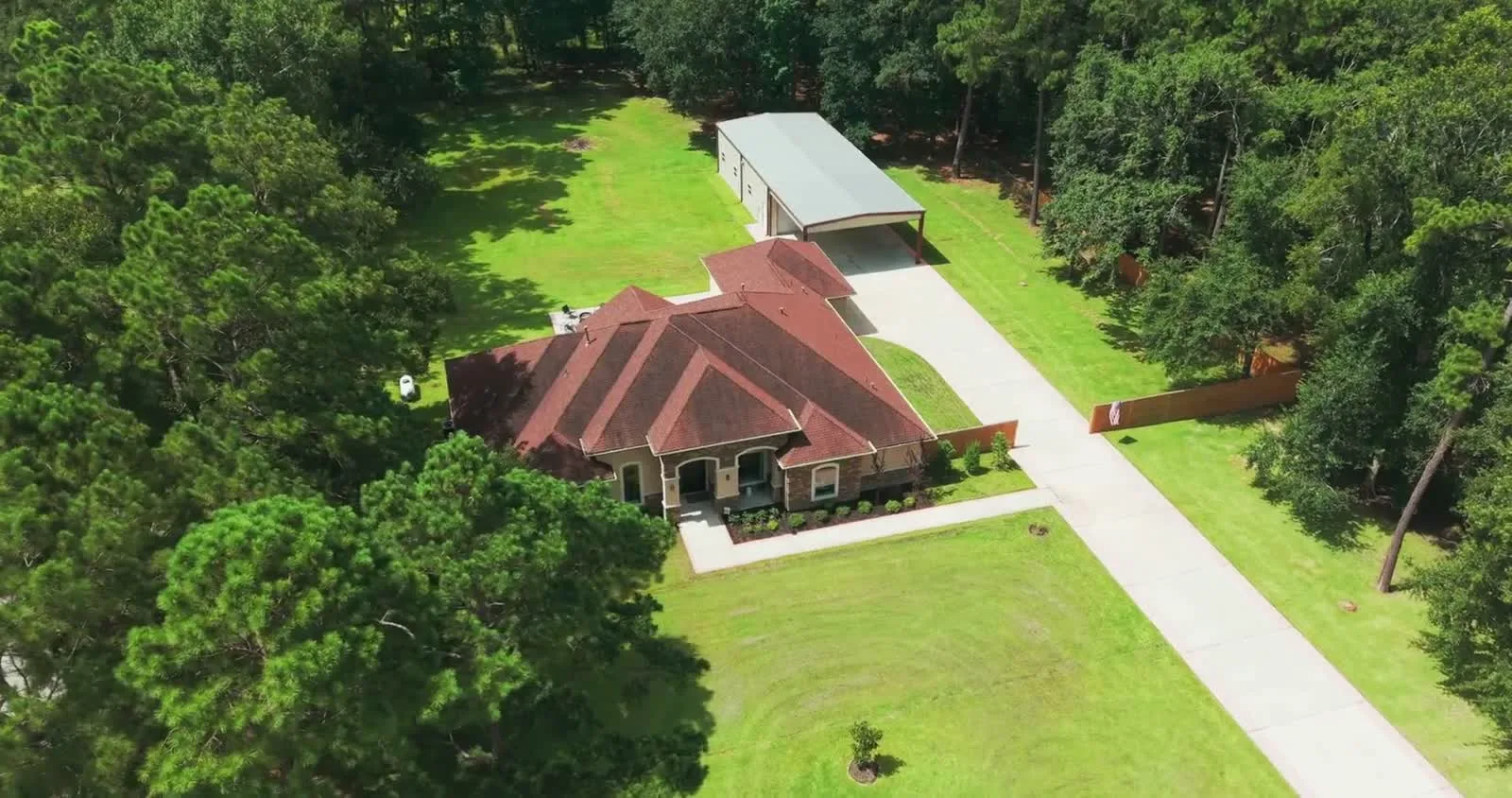 Mediterranean style one story home on a wooded lot with a wide lawn, Riverwalk, Porter, Texas